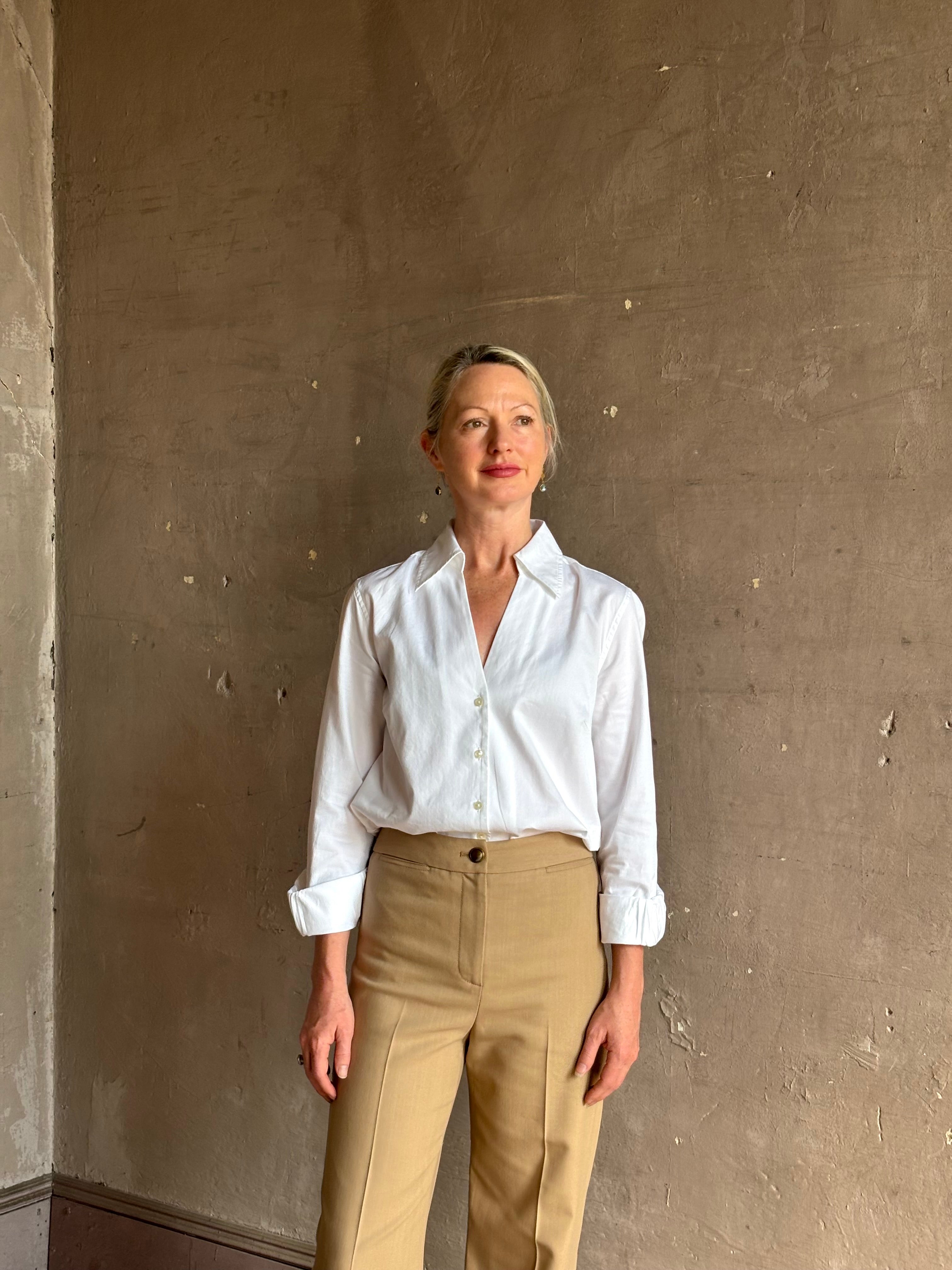 woman wearing white Trovata Justine blouse collared V-neck button-front closure cuffed long sleeves classic silhouette 