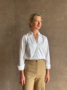 woman wearing white Trovata Justine blouse collared V-neck button-front closure cuffed long sleeves classic silhouette 