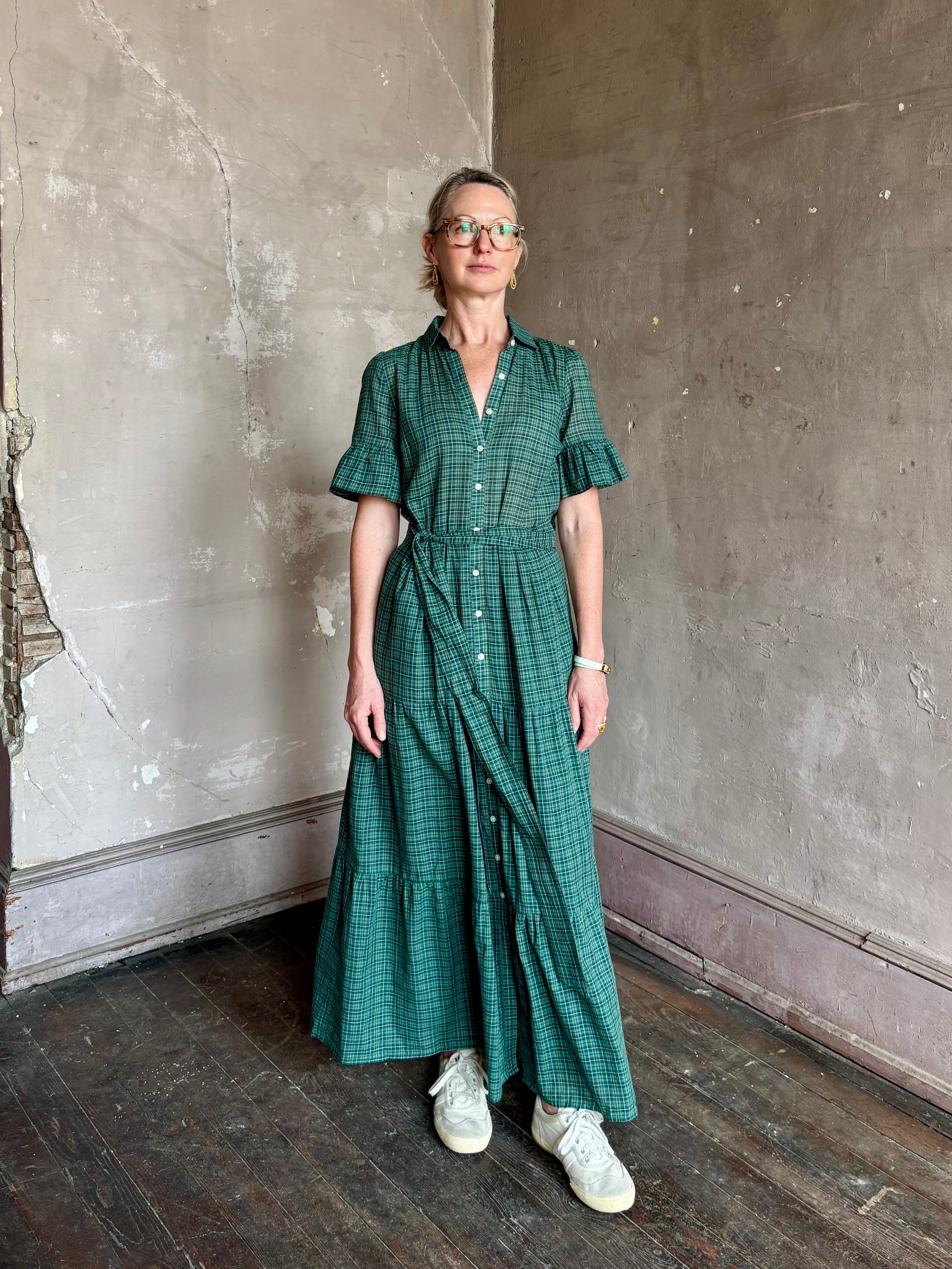 Mature woman wearing Trovata Martine button-up front cotton poplin green plaid maxi dress short sleeves and lightweight