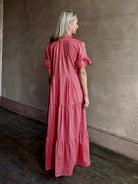 Image of woman wearing  TROVATA Martine button down cotton shirt dress in Rosdo rose with feminine ruffle sleeves and tiered skirt