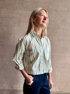 Image of woman wearing TROVATA Nessa cotton button down crop Shirt in Verde green and mint Stripes with long sleeves and collar