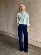 Image of woman wearing TROVATA Nessa cotton button down crop Shirt in Verde green and mint Stripes with long sleeves and collar