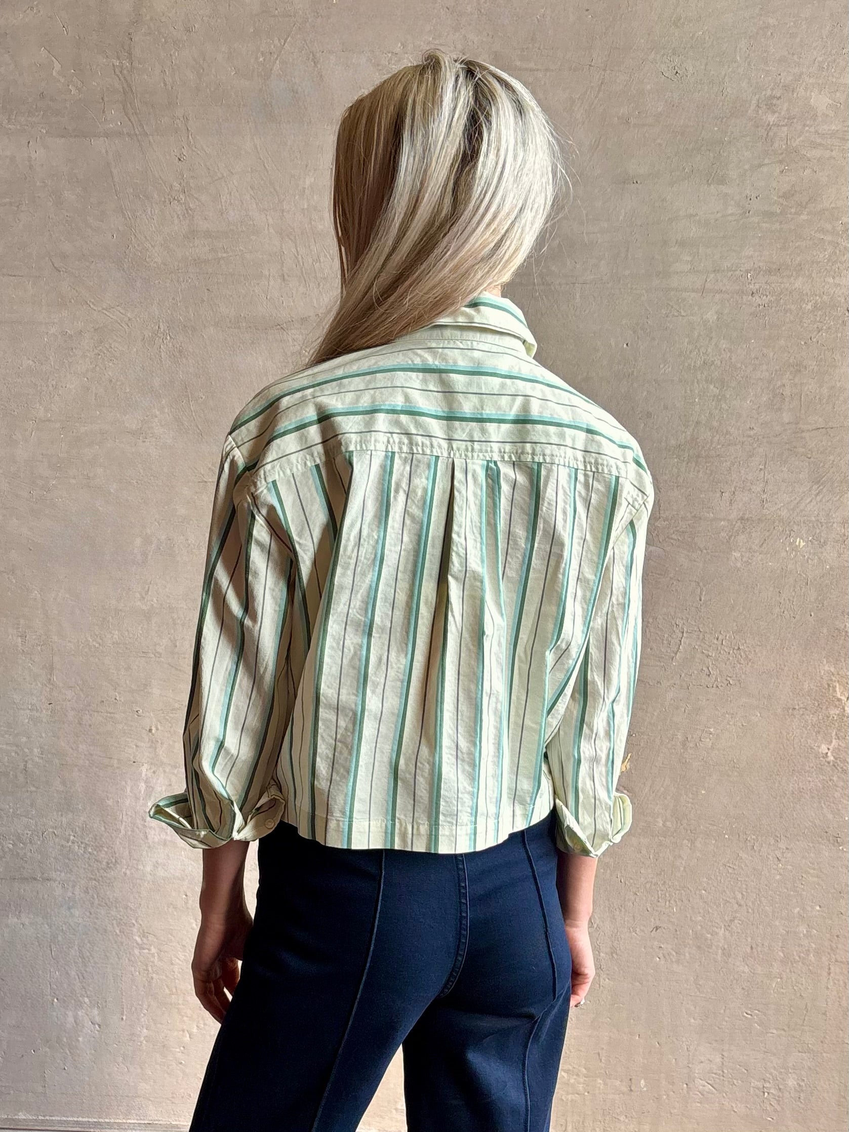 Image of woman wearing TROVATA Nessa cotton button down crop Shirt in Verde green and mint Stripes with long sleeves and collar