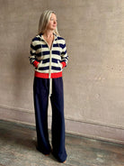 Mature woman wearing comfy cotton Rafa zip up hoodie by Trovata in a classic navy and white stripe with an elevated gold tone zipper.