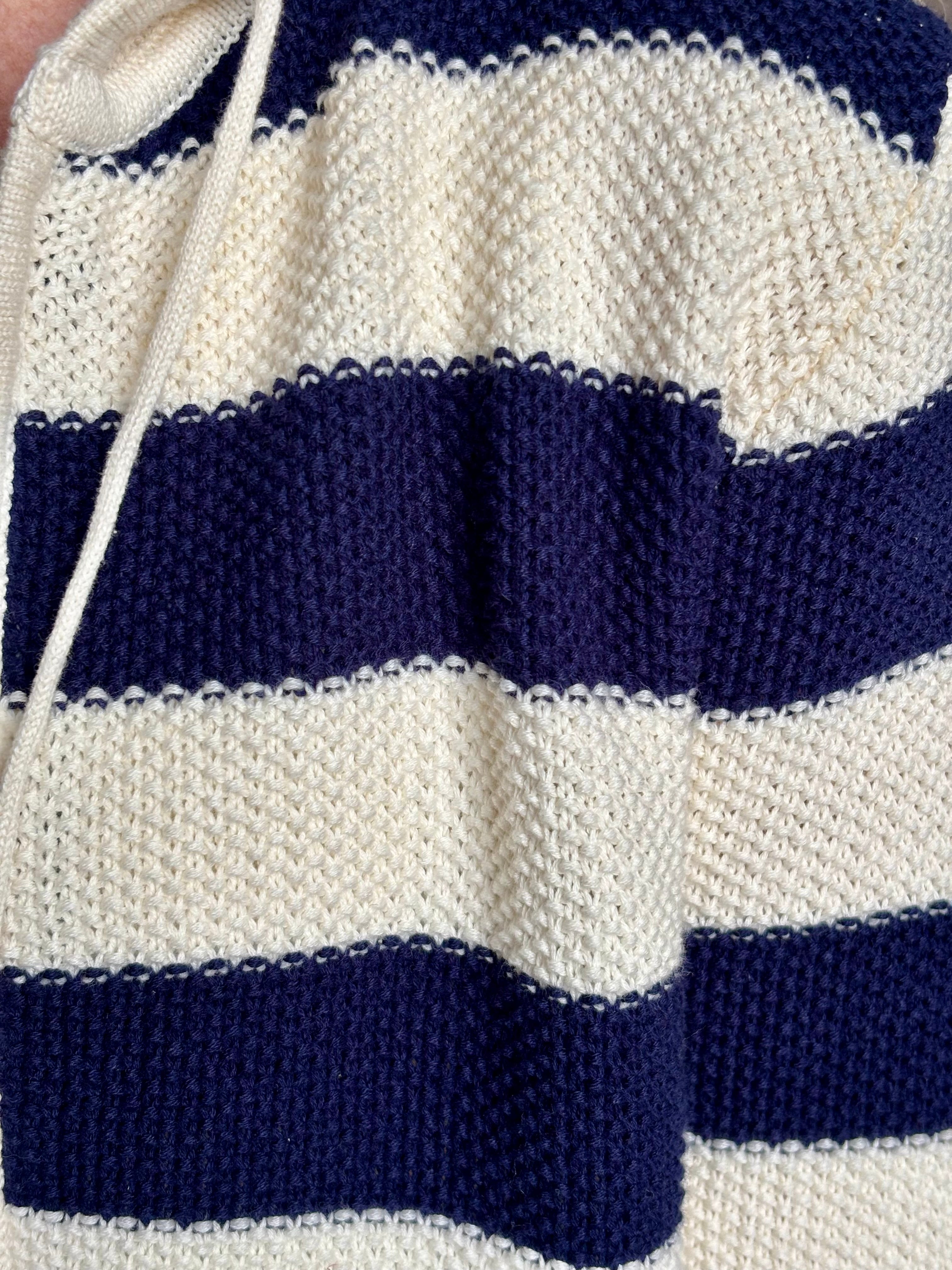 Mature woman wearing comfy cotton Rafa zip up hoodie by Trovata in a classic navy and white stripe with an elevated gold tone zipper.