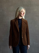 Mature woman wearing Trovata Skylar Cotton Corduroy Two Button Blazer in Walnut Brown front pockets heritage-inspired California tailoring