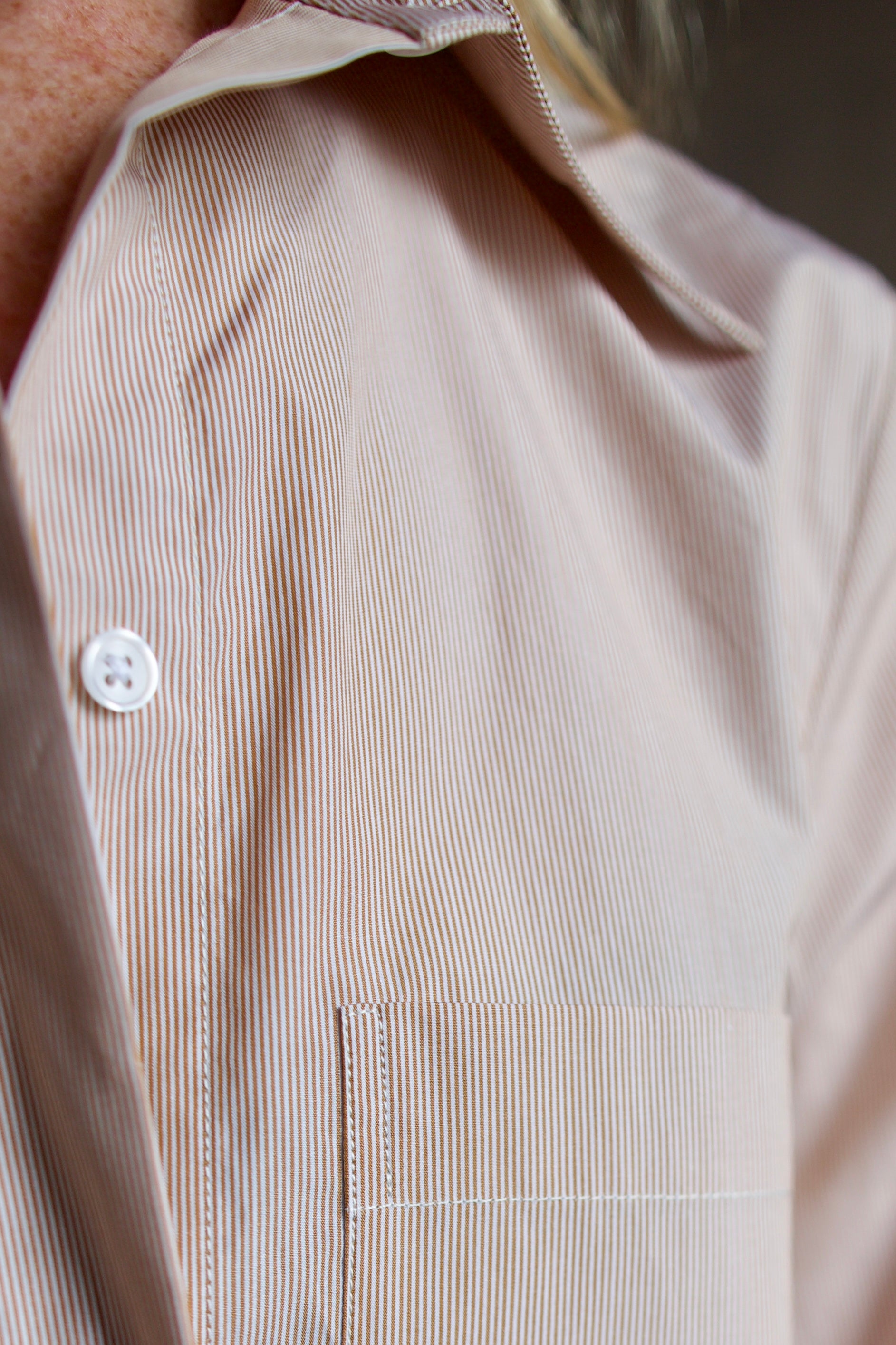 Close up image of sophisticated thin brown and white striped TWP boyfriend  shirt 