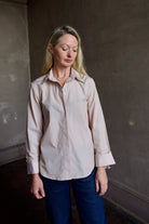 Image portraying classic elegance with model wearing striped TWP button down shirt and denim