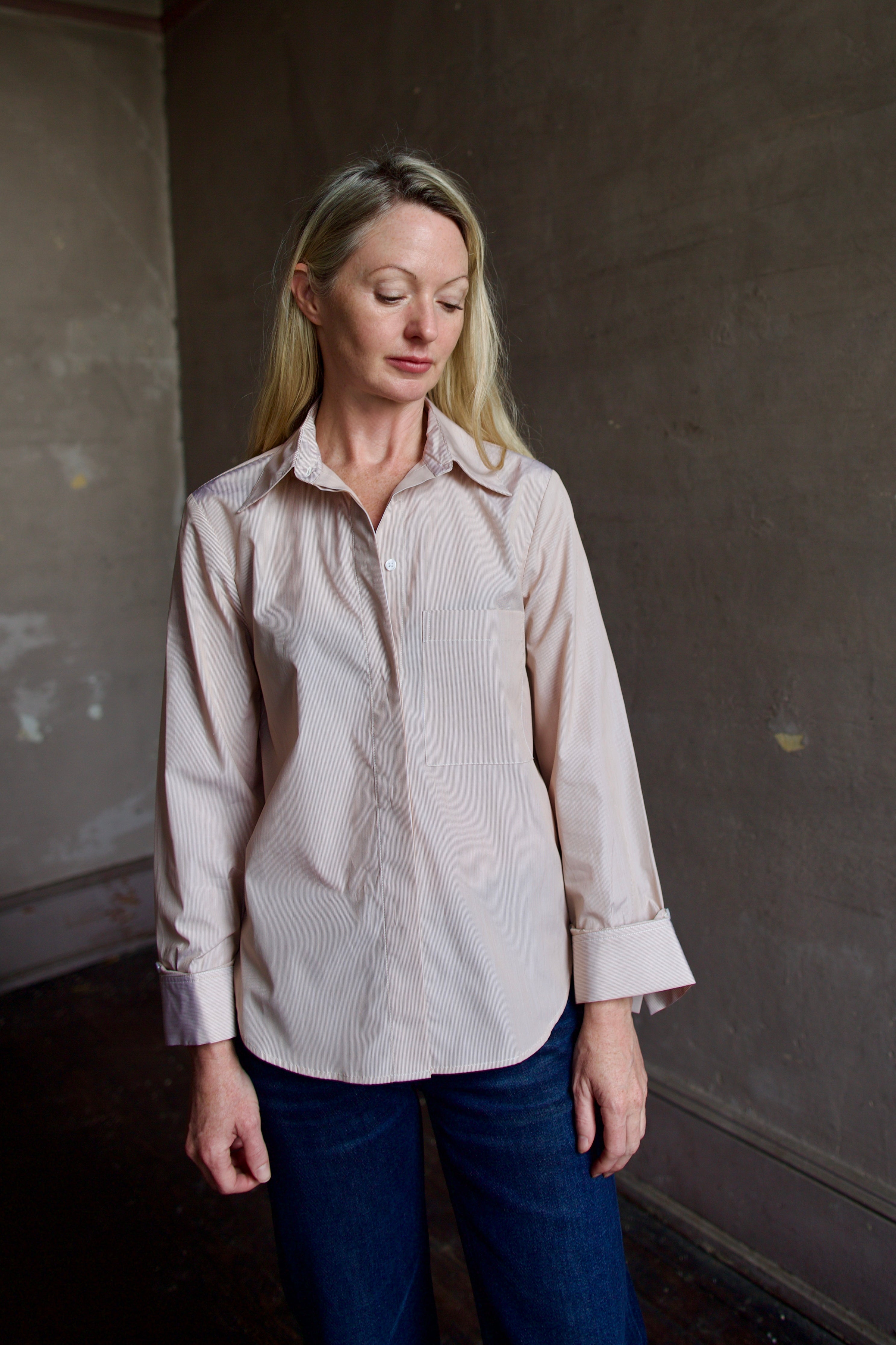 Image portraying classic elegance with model wearing striped TWP button down shirt and denim