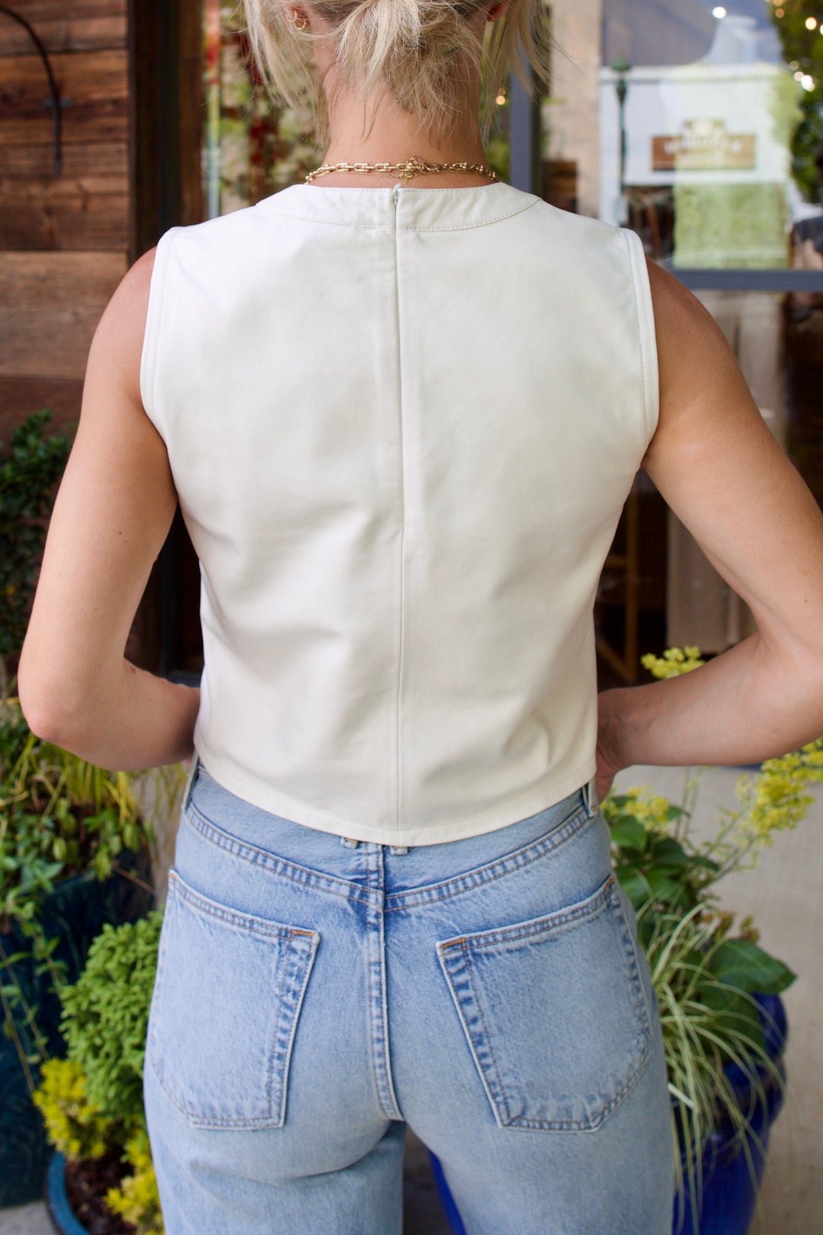 Mature woman wearing TWP Cropped Muscle Tank in Bone 100% lamb leather crew neck and oversized pocket. Made in USA buttery utilitarian-edged luxury