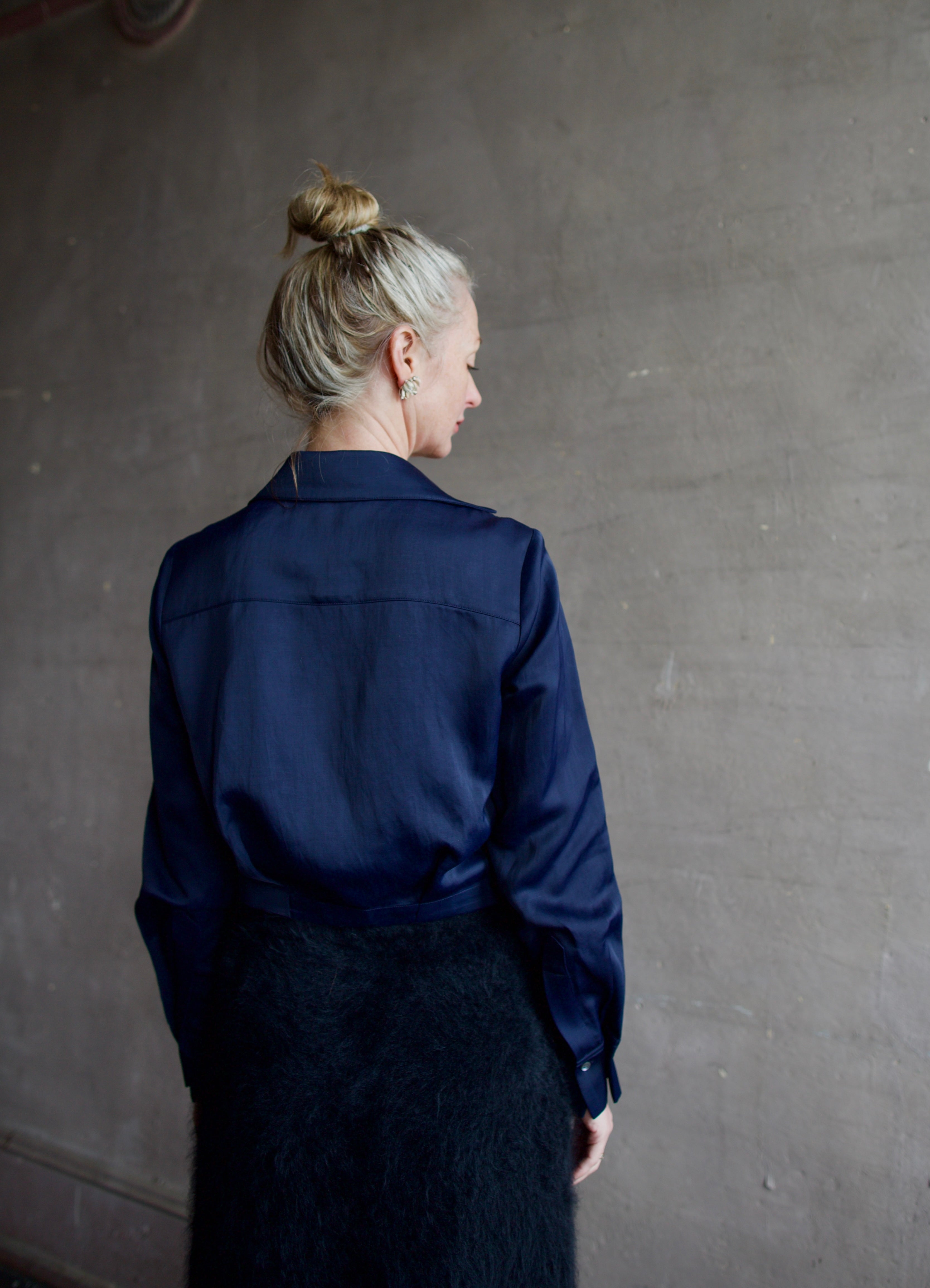 Mature woman wearing luxury women's viscose-linen TWP GT Goan navy blouse featuring cropped fit with wrap waistline and deep v-neckline