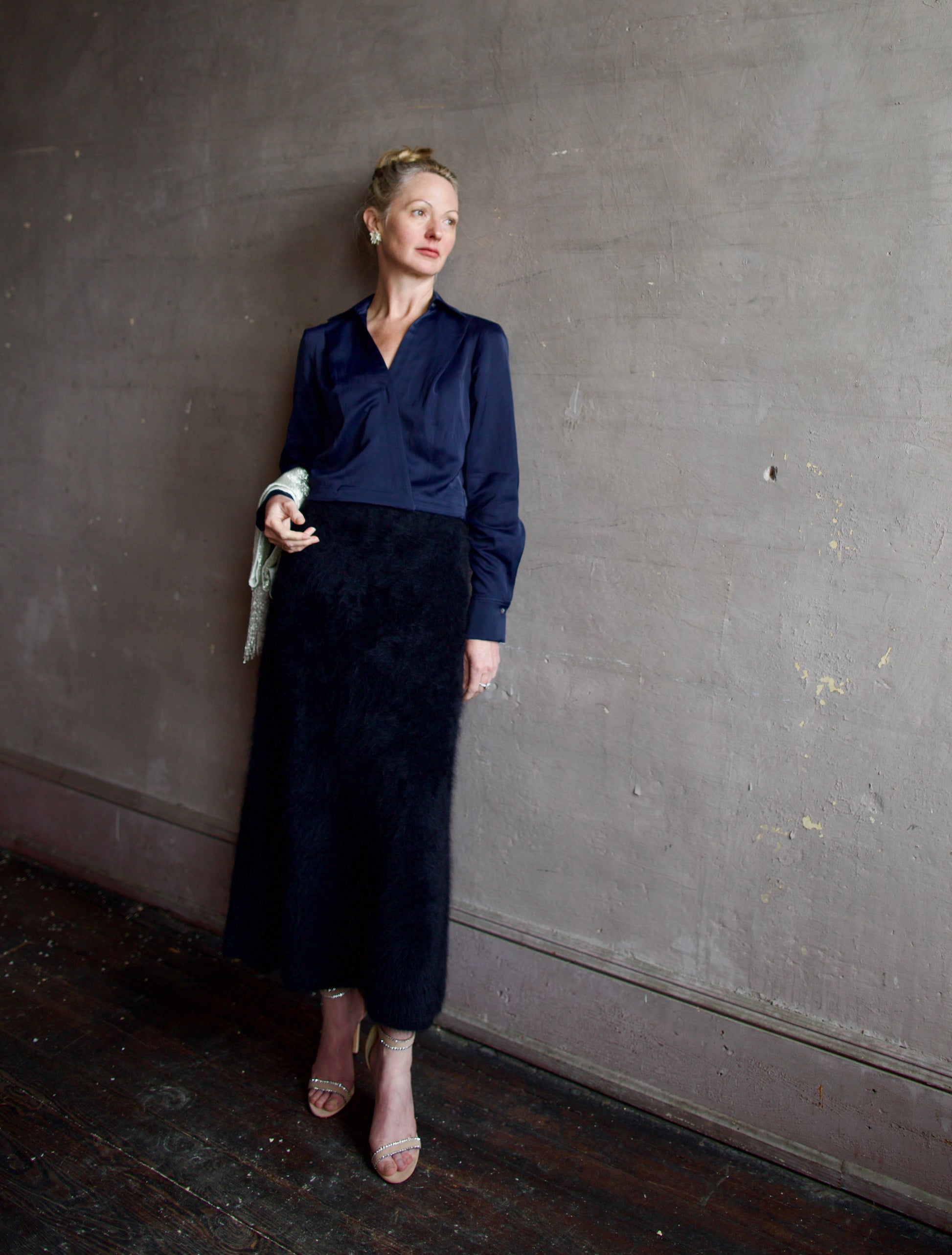 image of a woman wearing the TWP GT Goan blouse with the Lisa Yang brushed cashmere skirt, Anna Johnson depleted silver earrings and TWP beaded scarf