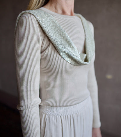 close up image of a woman wearing the TWP ribbed top and beaded scarf