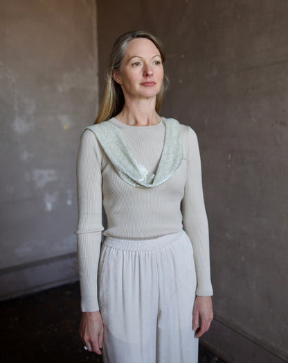 image of a woman wearing the TWP ribbed top and beaded scarf with the Forte Forte corduroy pants