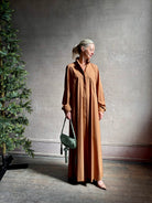 Mature woman wearing sophisticated TWP Jennys shirt dress embellished with crystals in warm brown
