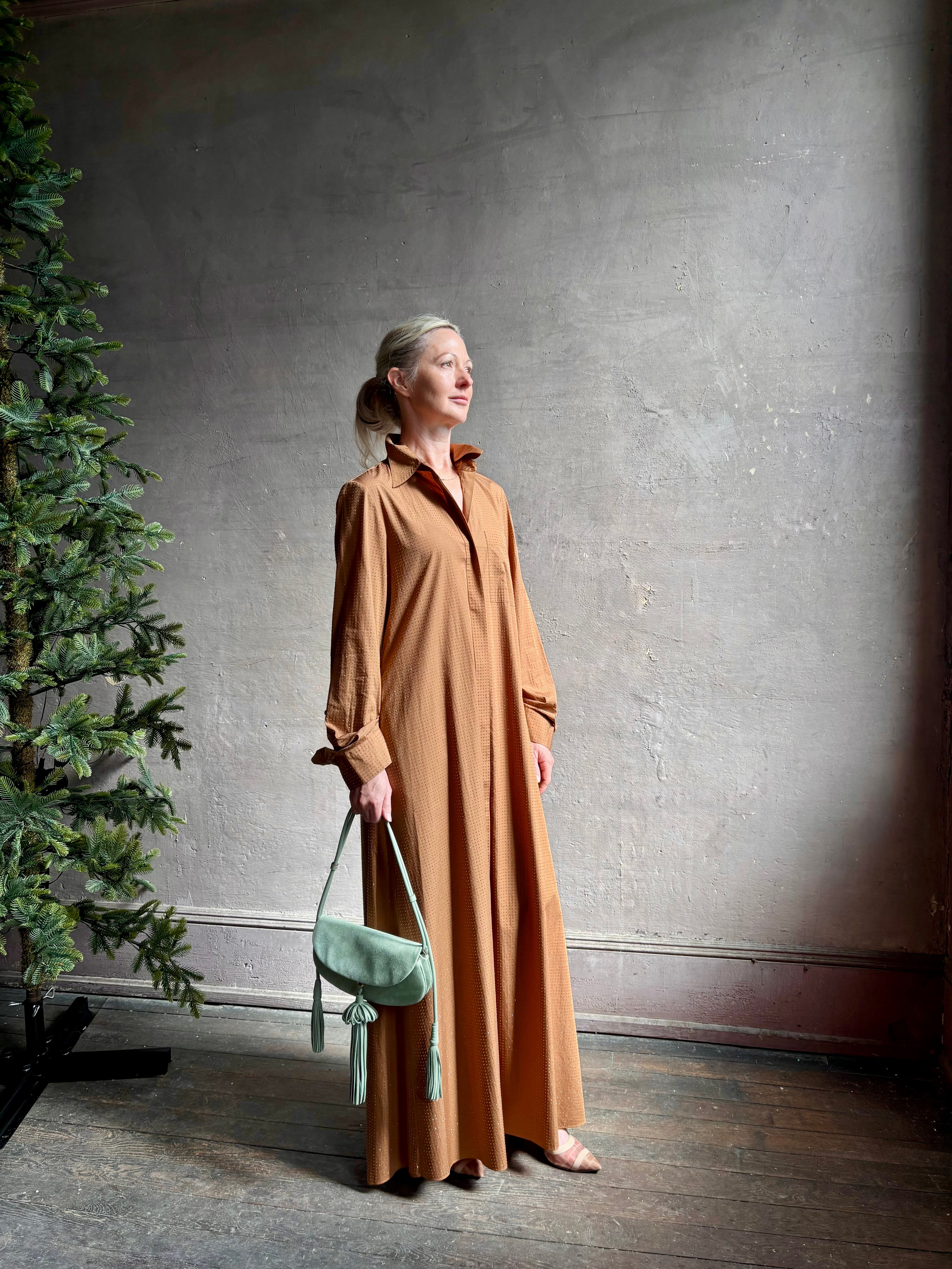 Mature woman wearing sophisticated TWP Jennys shirt dress embellished with crystals in warm brown