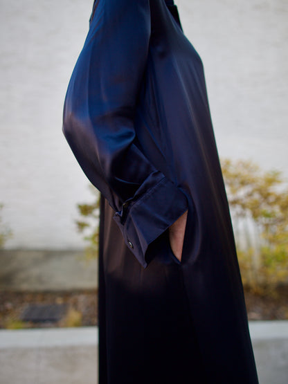 Image featuring a woman modeling the TWP Jennys oversized maxi shirt dress in sleek navy blue silk charmeuse.