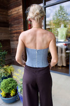 Back image of a woman wearing the TWP Jillian Bustier and Dees Trousers