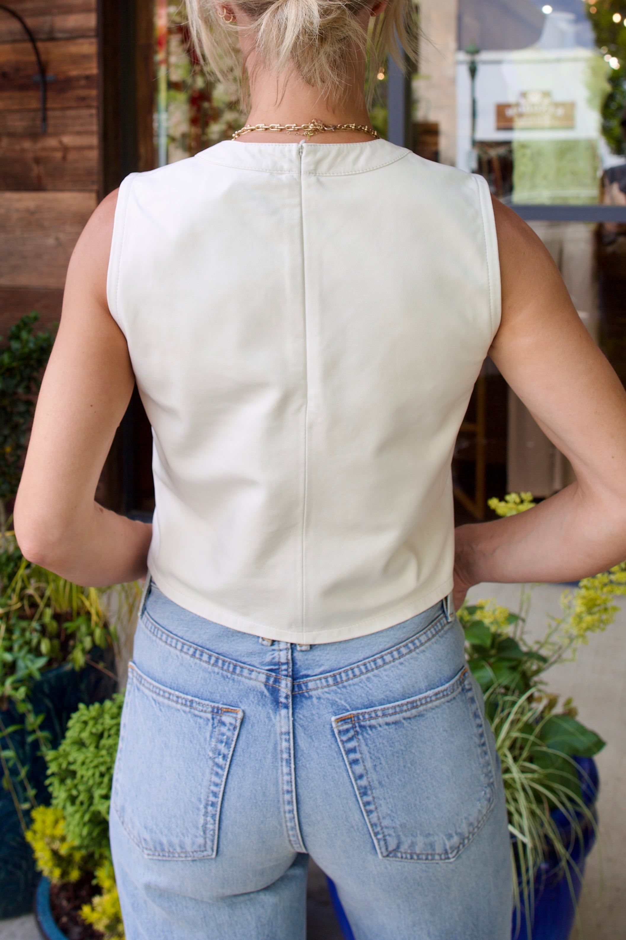 Woman wearing contemporary luxury fashion TWP lamb skin off white Leather Tank top  elevated casual wear