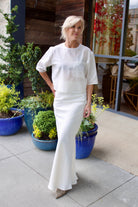 Image of a woman wearing the TWP New Ex Tee and My Endless Love Skirt