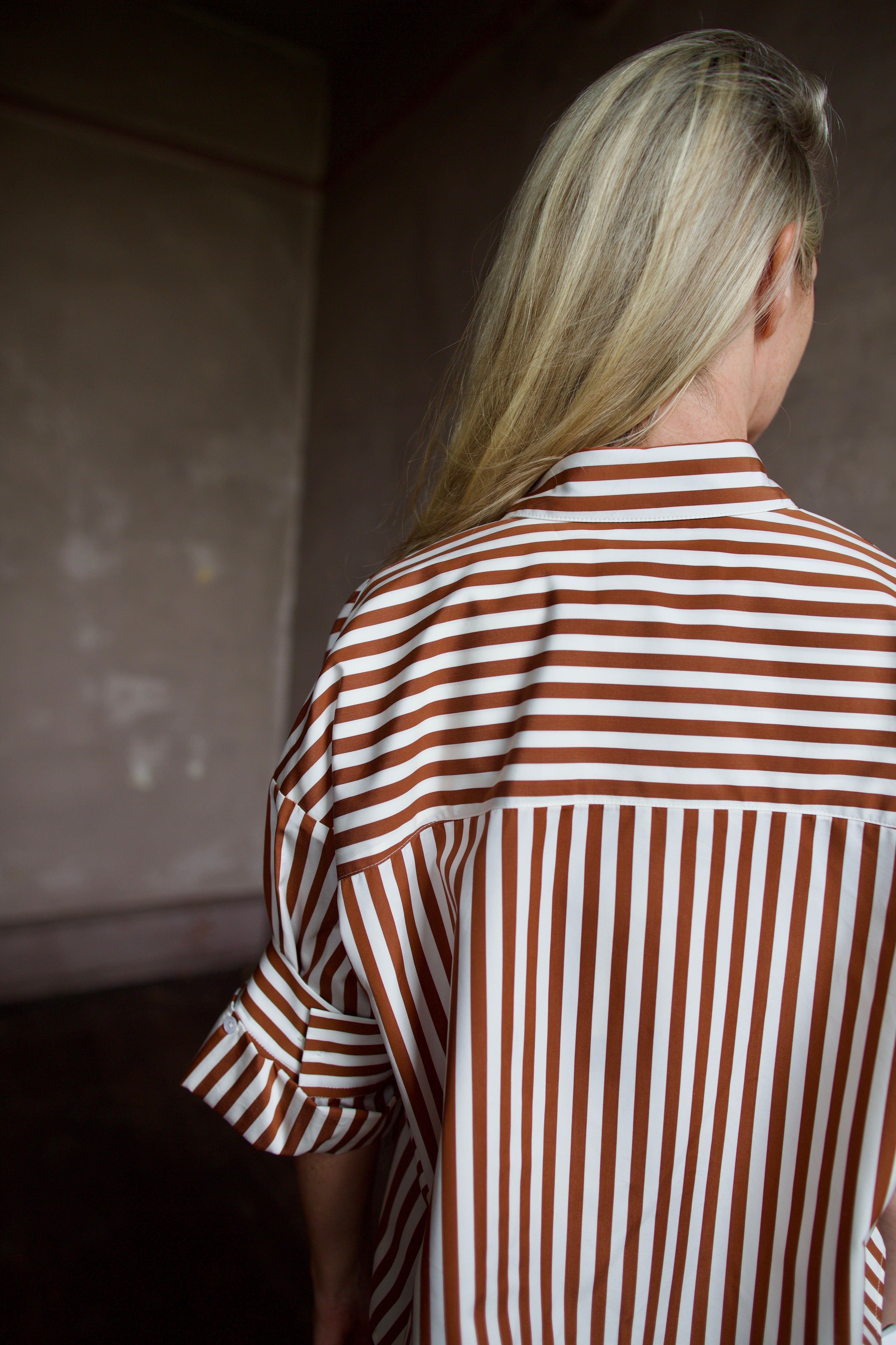 Close up image of mature model wearing comfortable luxury brand TWP striped Next Ex shirt 