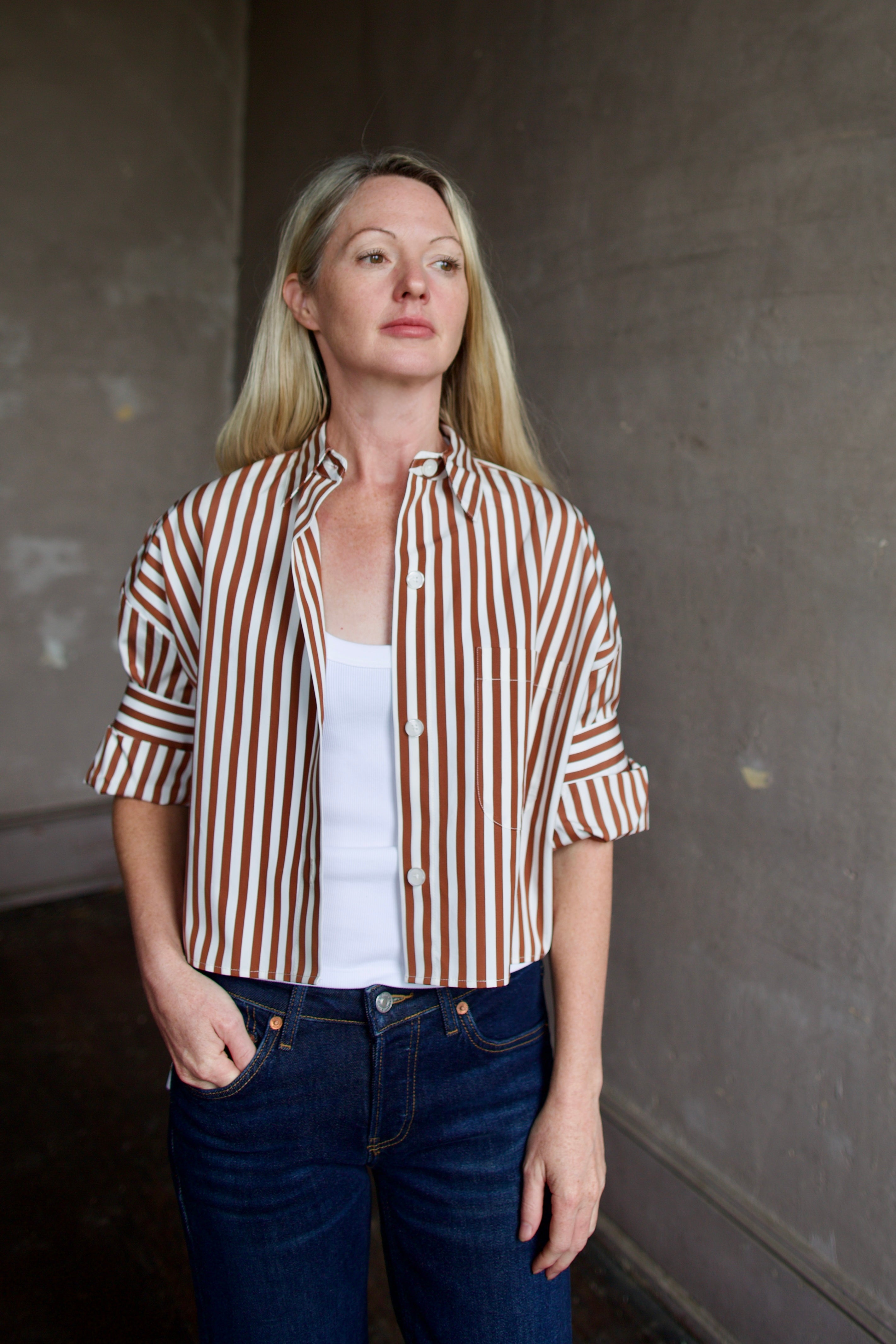 Image of mature model wearing comfortable luxury brand TWP striped Next Ex shirt with dark denim
