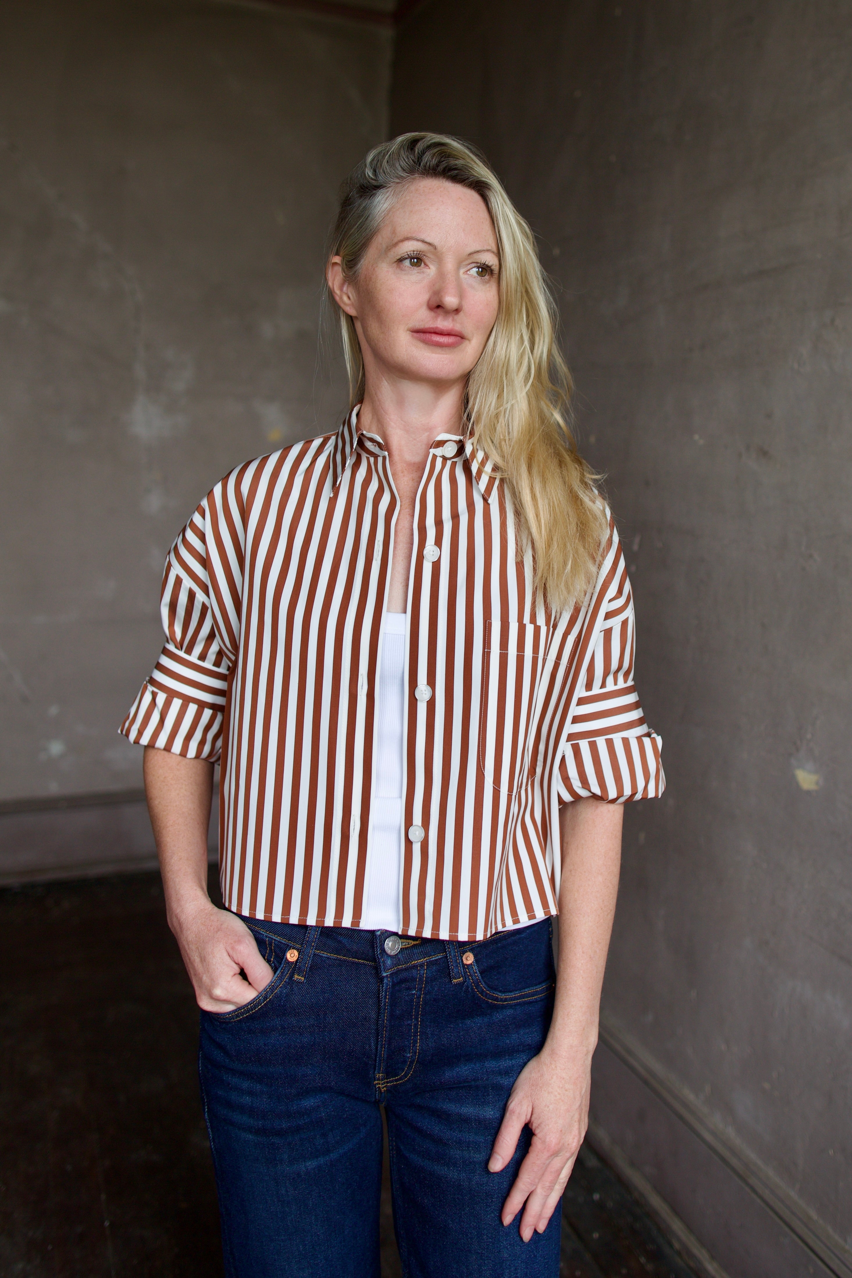 Image of mature model wearing comfortable luxury brand TWP striped Next Ex shirt with dark denim
