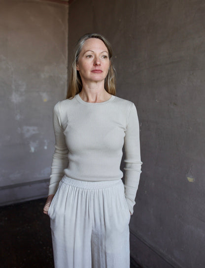 Image of woman wearing the TWP Secondskin wool top and forte forte corduroy pants