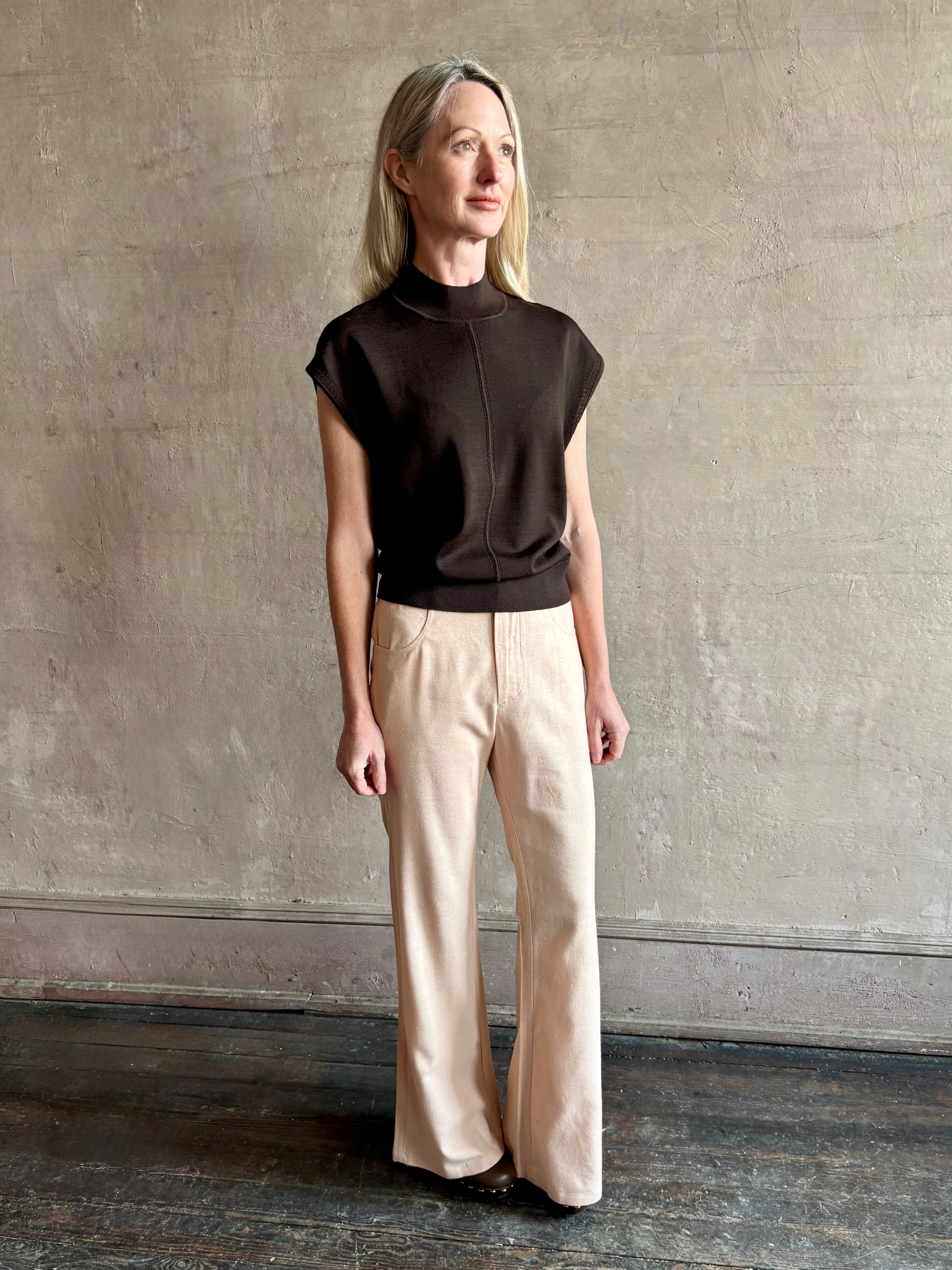 Woman wearing TWP Chocolate brown Wren Sweater in  Premium Merino Wool  Knitwear with mock neck and cap sleeve