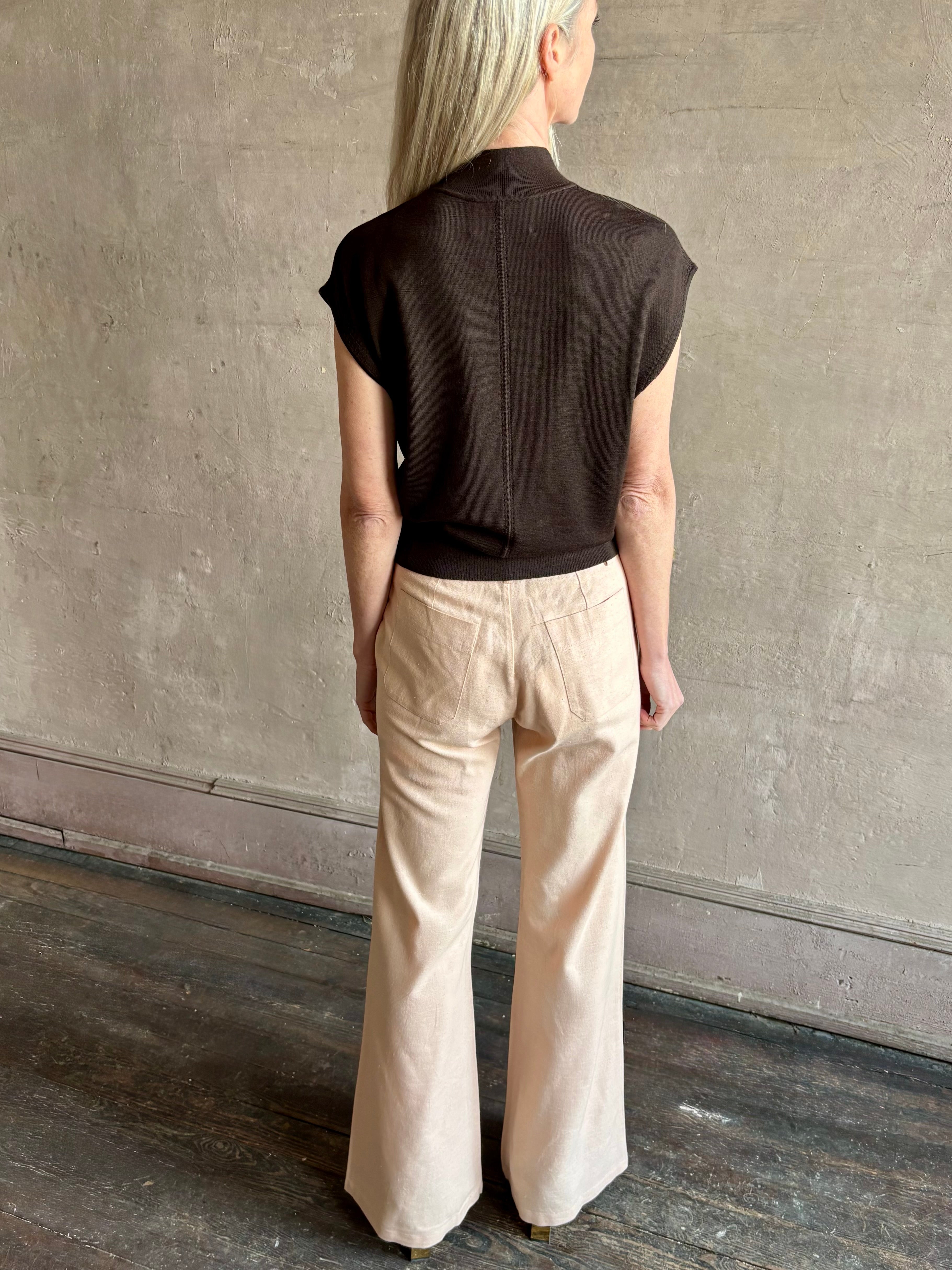 Woman wearing TWP Chocolate brown Wren Sweater in  Premium Merino Wool  Knitwear with mock neck and cap 