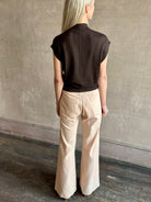 Woman wearing TWP Chocolate brown Wren Sweater in  Premium Merino Wool  Knitwear with mock neck and cap 