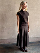 Woman wearing TWP Chocolate brown Wren Sweater  and matching skirt set in  Premium Merino Wool  Knitwear 
