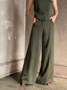 Mature woman wearing luxury women's clothing brand TWP Green Demie wide leg trouser linen viscose blend fabric