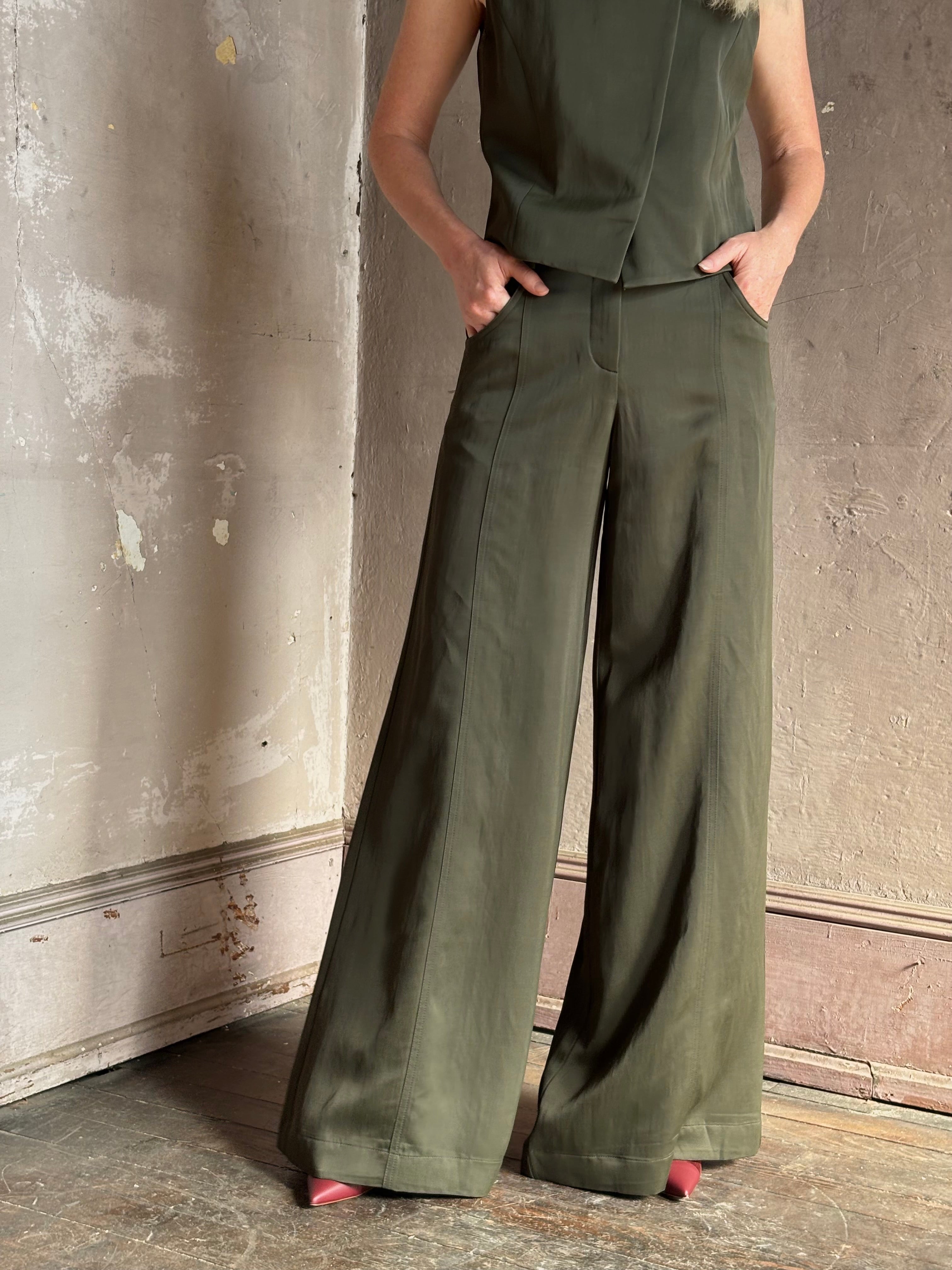Mature woman wearing luxury women's clothing brand TWP Green Demie wide leg trouser linen viscose blend fabric