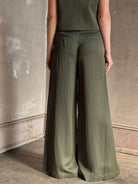 Mature woman wearing luxury women's clothing brand TWP Green Demie wide leg trouser linen viscose blend fabric