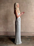 Mature woman wearing the Dillon pant from TWP in an effortlessly sophisticated hemp trouser with an airy wide leg and back pockets