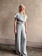 Mature woman wearing the Dillon pant from TWP in an effortlessly sophisticated hemp trouser with an airy wide leg and back pockets