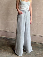 Mature woman wearing the Dillon pant from TWP in an effortlessly sophisticated hemp trouser with an airy wide leg and back pockets