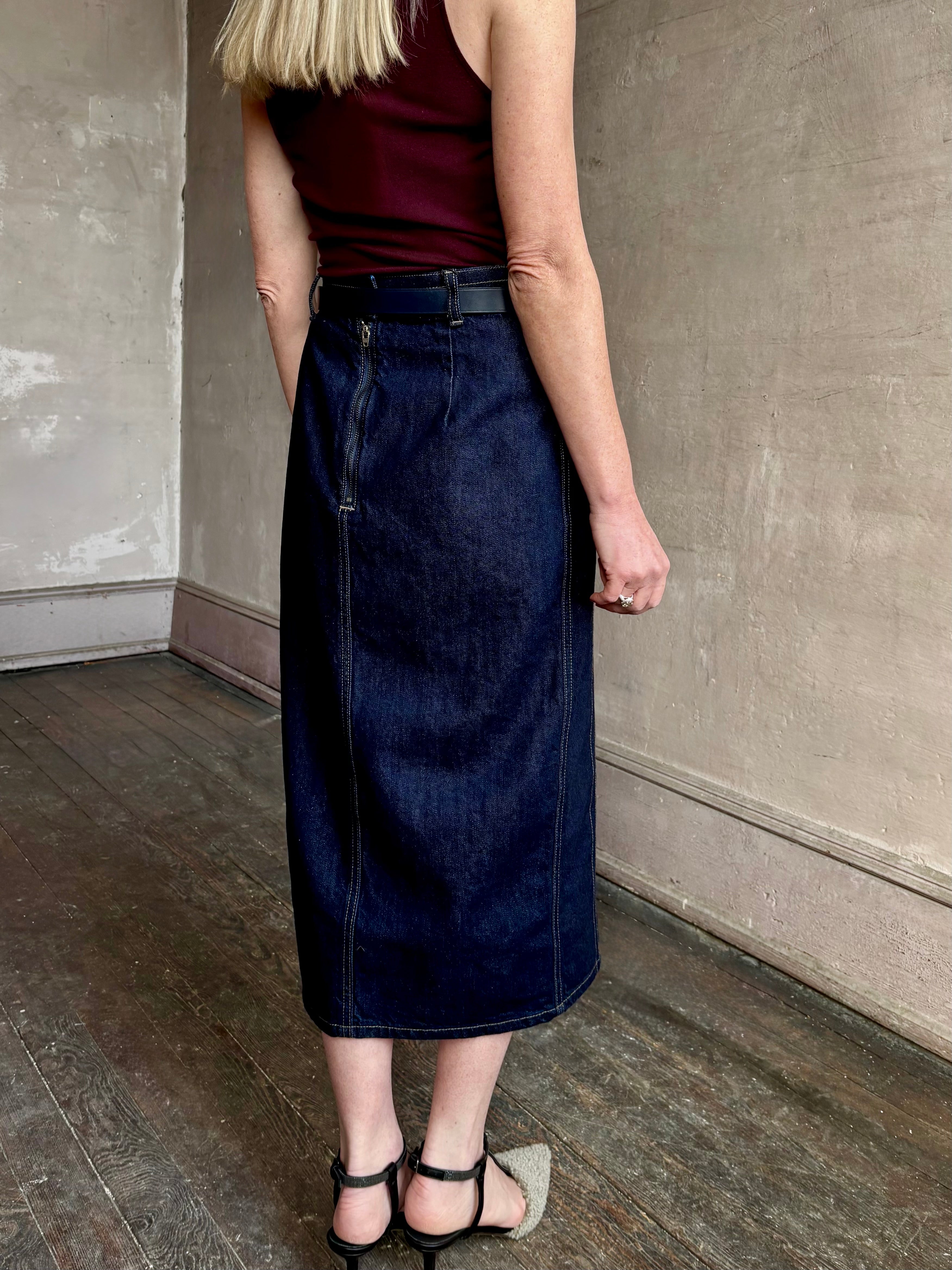 Image of mature woman wearing Premium Cotton American-Made Denim  maxi skirt by TWP with Seams and front vent in Dark Stone wash
