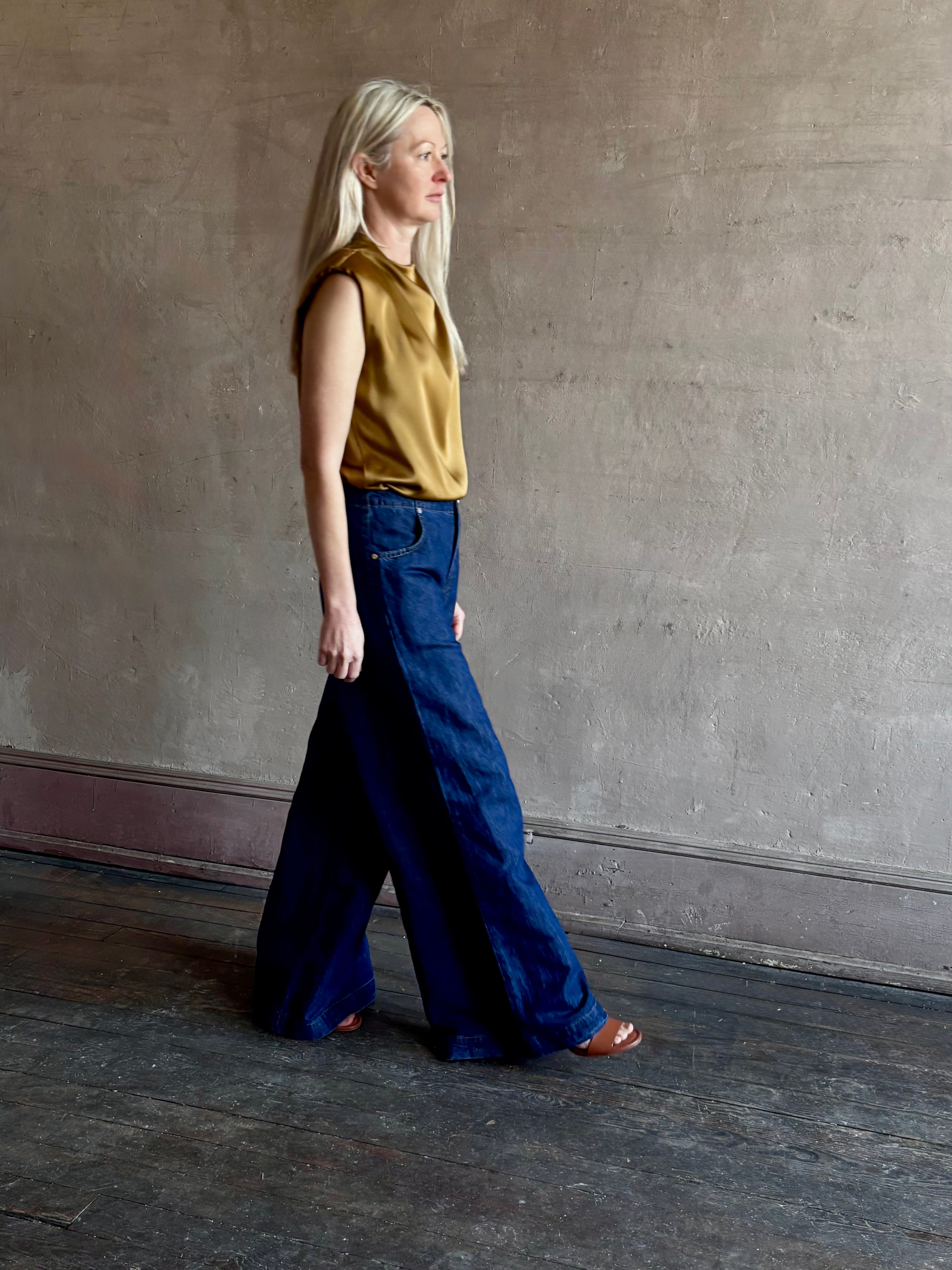 Image of woman wearing designer TWP Dillon cotton linen Denim in Dark Stone wash that is Made in USA with mid-rise and wide leg