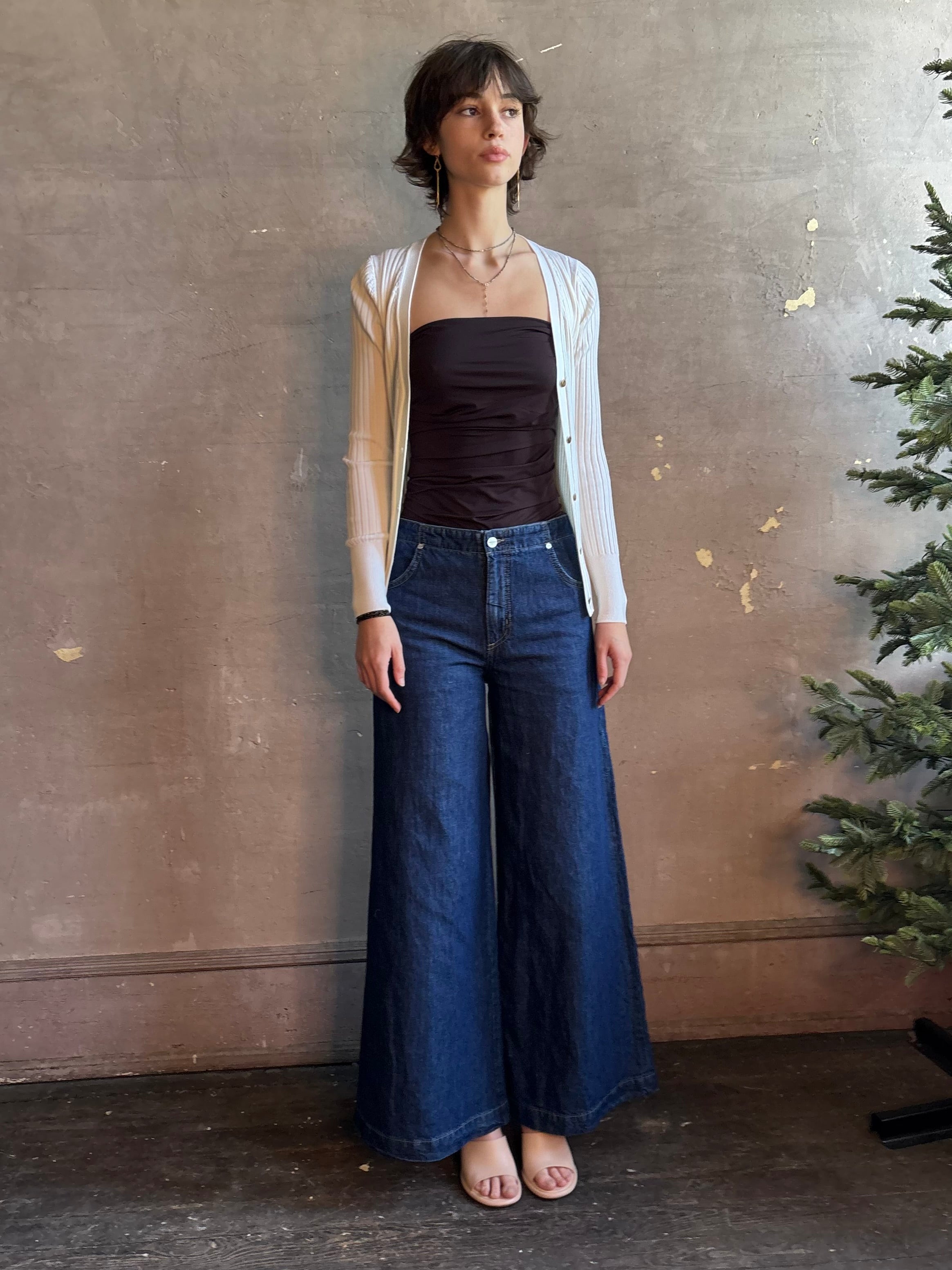 Woman wearing luxury designer TWP Dillon cotton linen Denim in Dark Stone wash that is Made in USA with mid-rise and wide leg