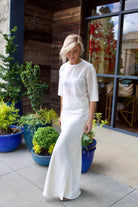Woman wearing sophisticated luxury TWP coated linen My Endless Love off-white maxi Skirt with expert slim tailoring and subtle bottom flare made in USA