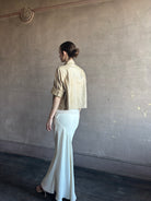 Woman wearing sophisticated luxury TWP coated linen My Endless Love cream colored maxi Skirt with expert slim tailoring and subtle bottom flare made in USA