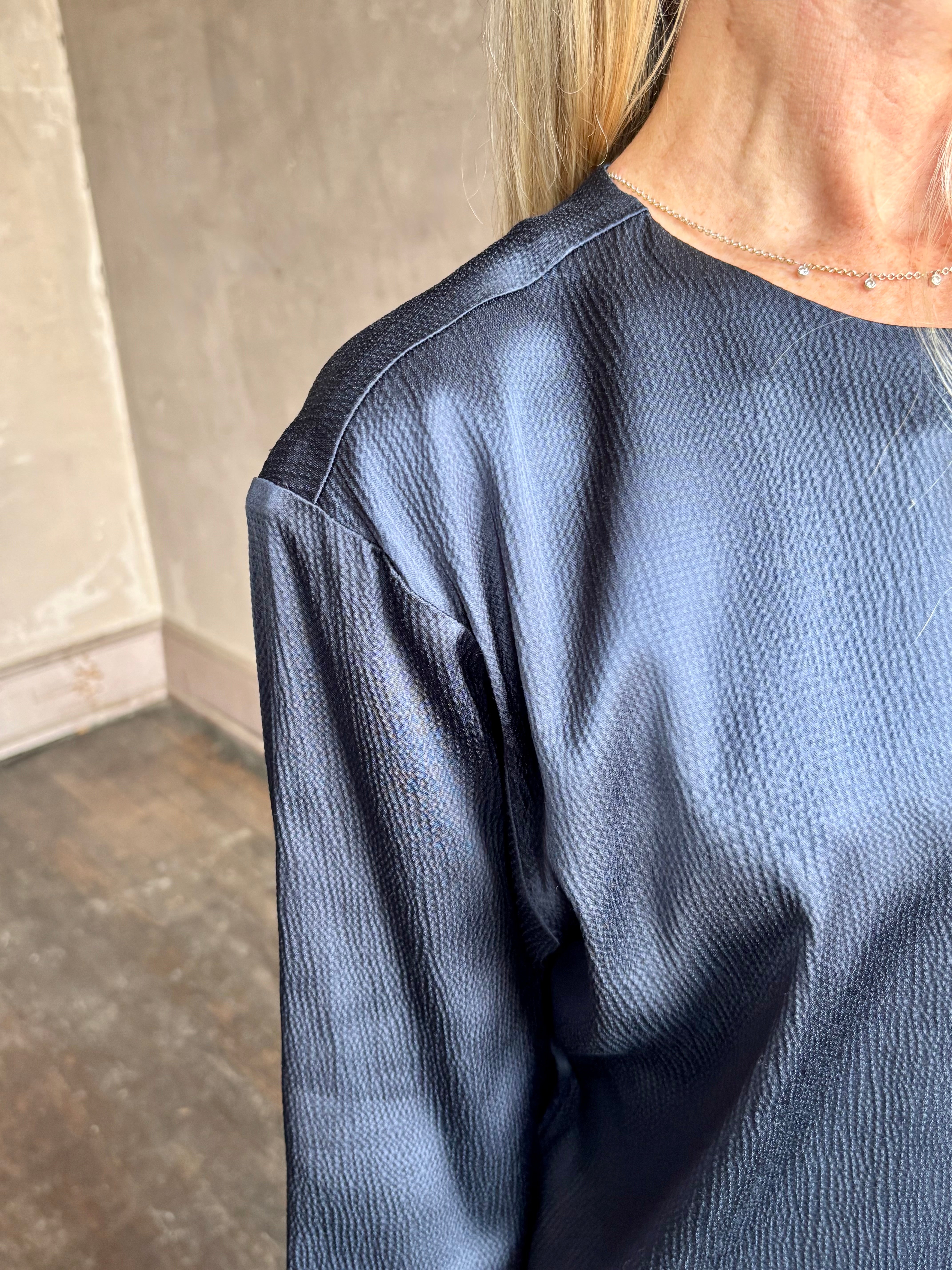 Image of mature woman wearing TWP Ex T in premium hammered satin with short sleeve crew neck and a casual front pocket