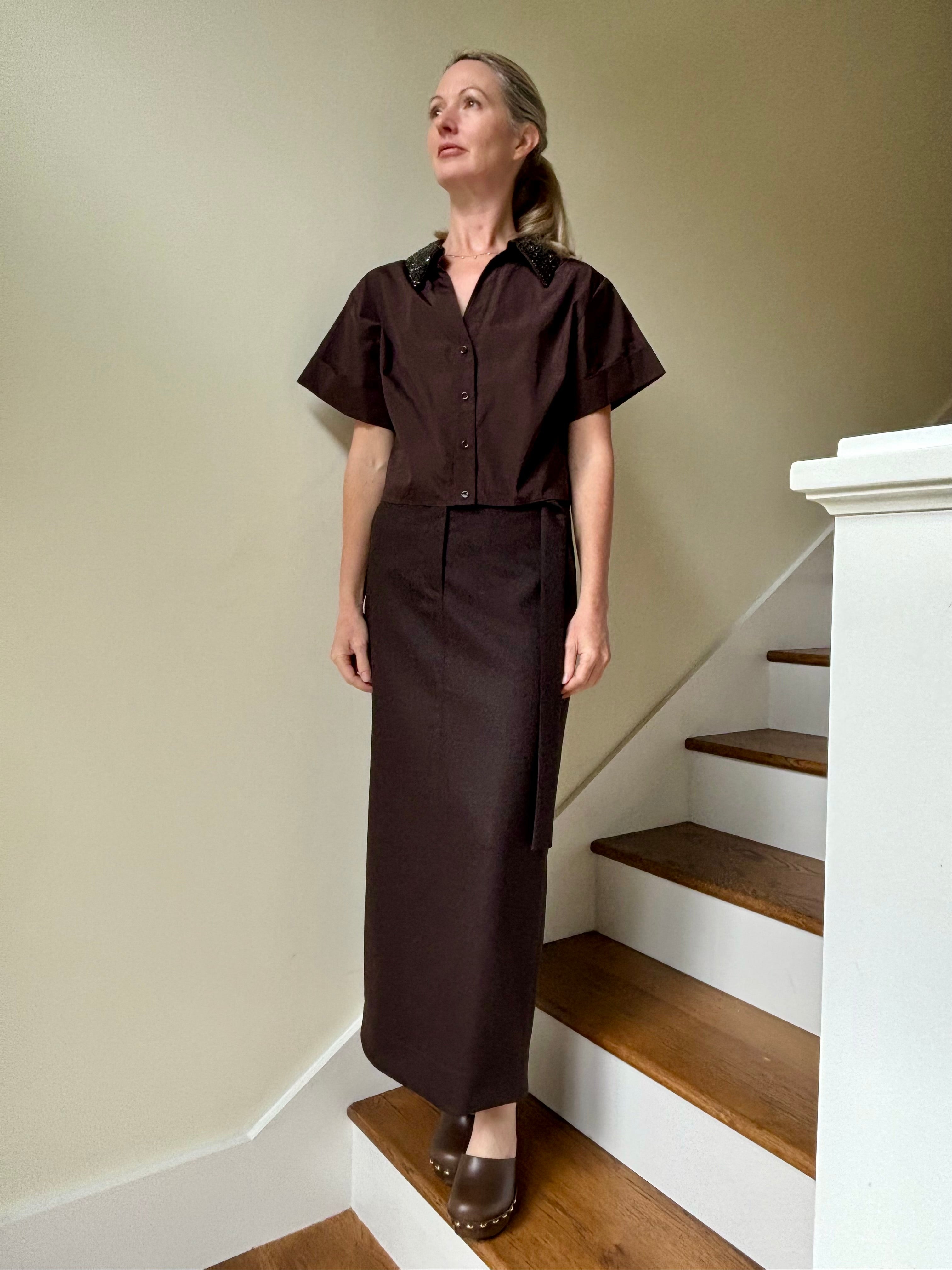 Image of mature woman wearing luxury TWP premium cotton blouse with a crystal collar in a rich chocolate color that's reversible