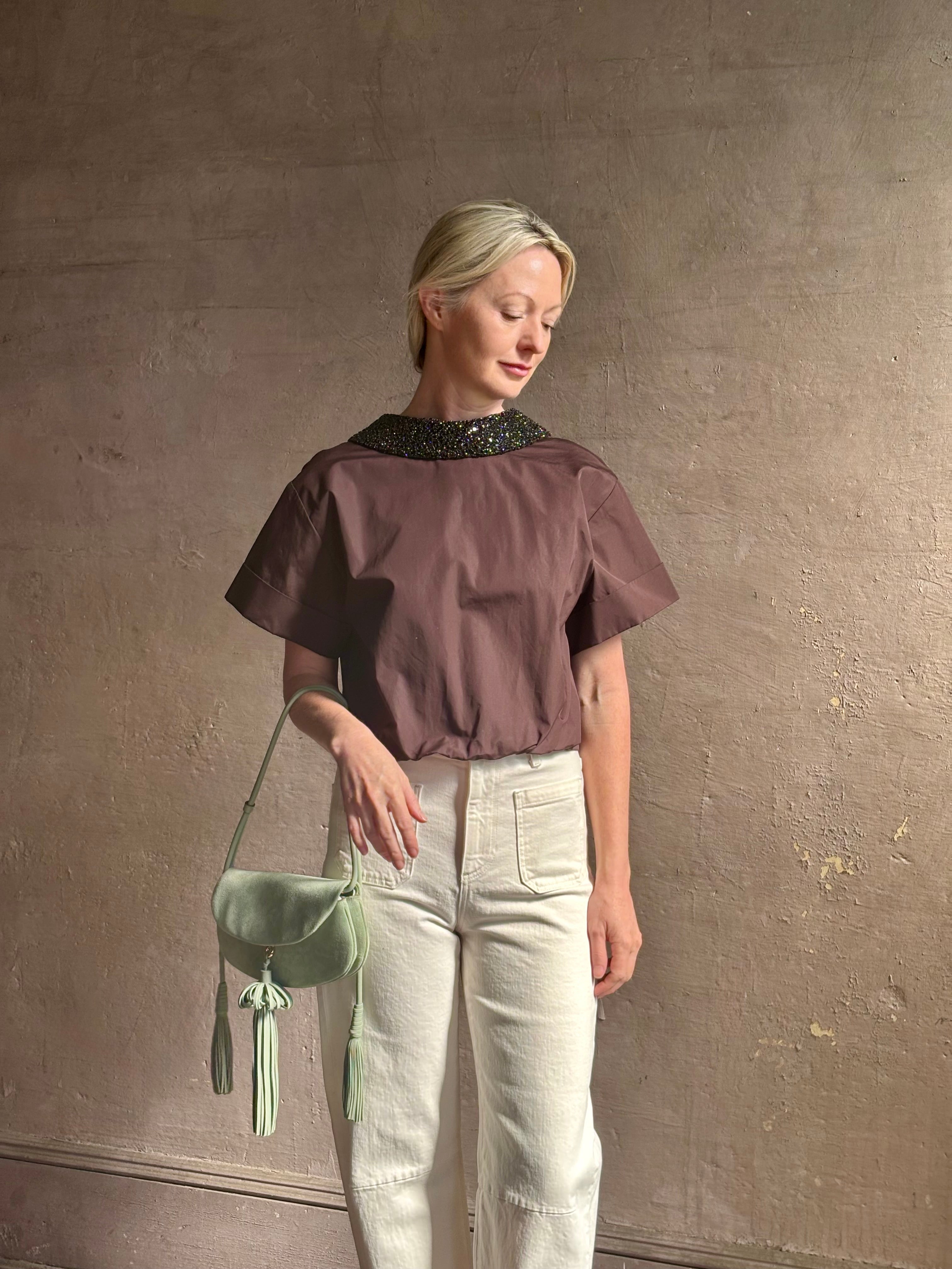 Mature woman wearing Forever and Always with Crystal Collar Top from TWP women's luxury designer blouse rendered in chocolate brown and crafted from 100% cotton in the USA with crystal collar, short sleeves and reversible