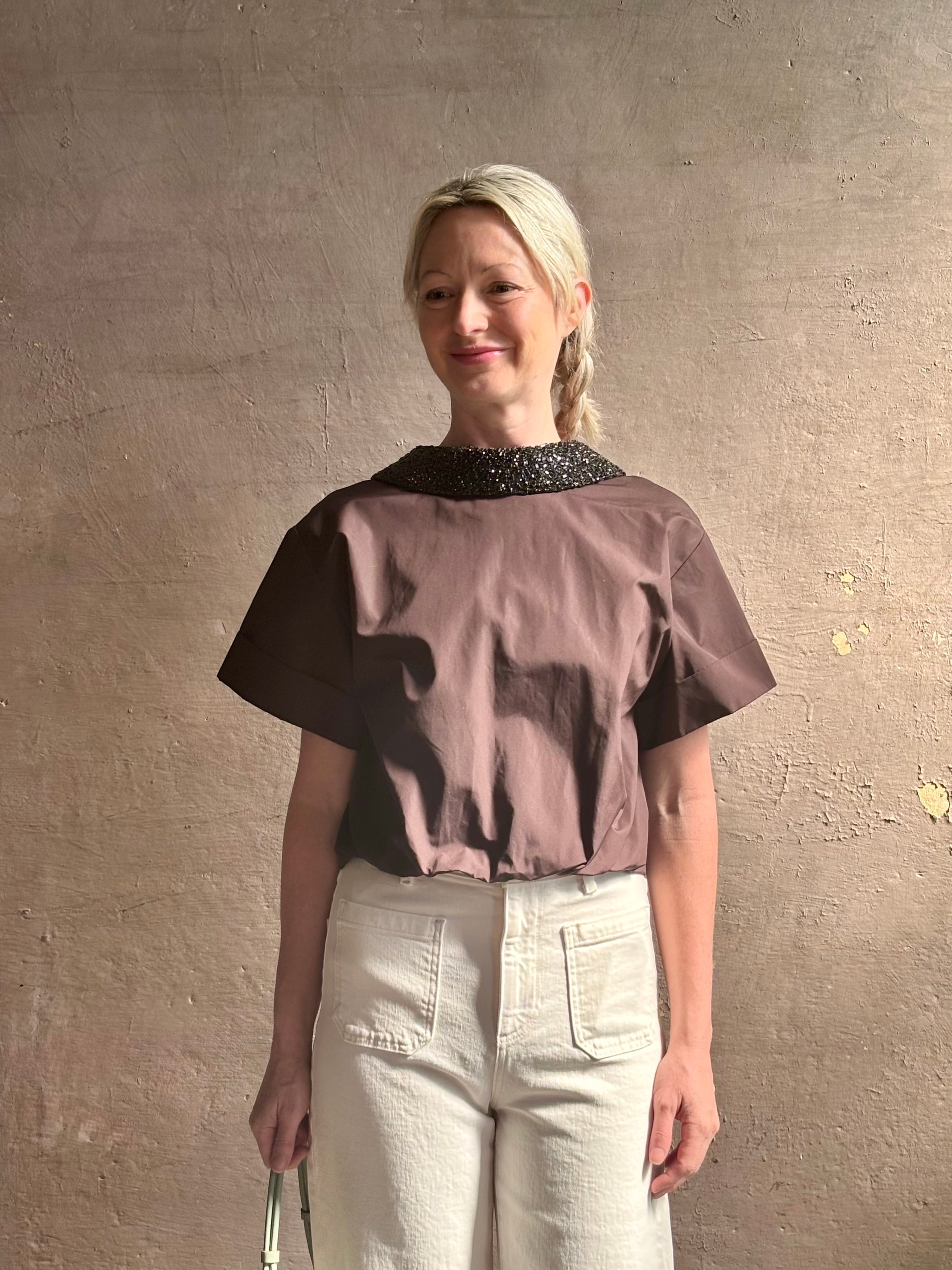 Mature woman wearing Forever and Always with Crystal Collar Top from TWP women's luxury designer blouse rendered in chocolate brown and crafted from 100% cotton in the USA with crystal collar, short sleeves and reversible