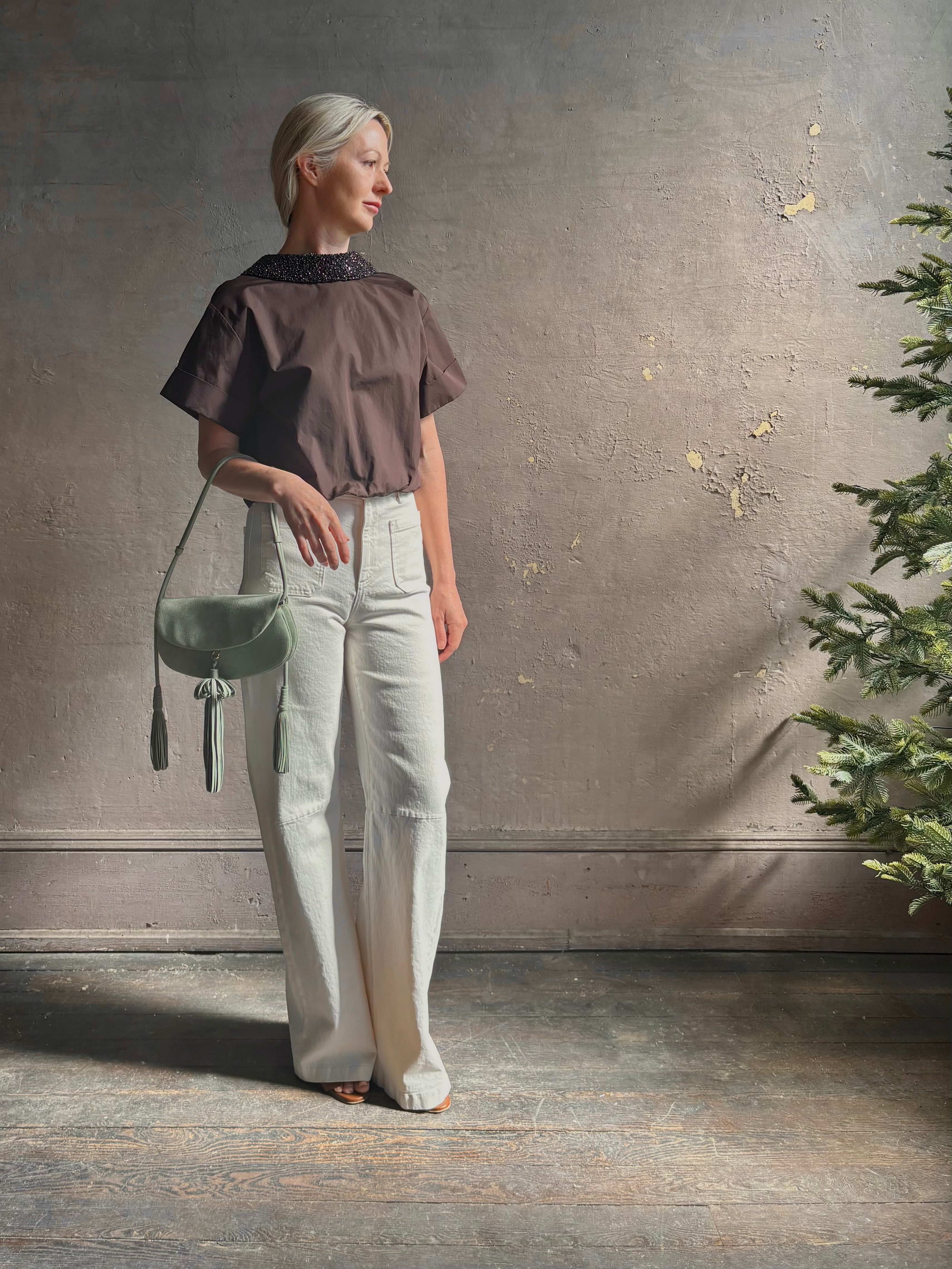 Mature woman wearing Forever and Always with Crystal Collar Top from TWP women's luxury designer blouse rendered in chocolate brown and crafted from 100% cotton in the USA with crystal collar, short sleeves and reversible