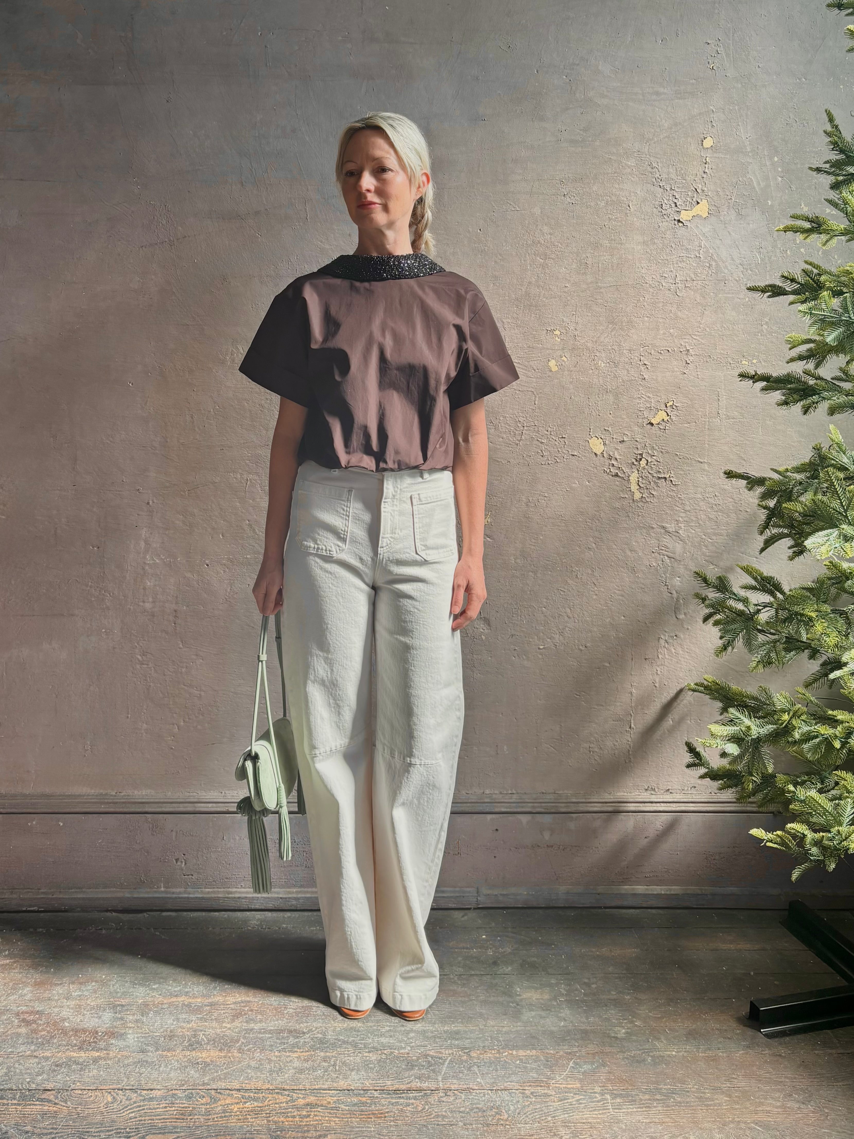 Mature woman wearing Forever and Always with Crystal Collar Top from TWP women's luxury designer blouse rendered in chocolate brown and crafted from 100% cotton in the USA with crystal collar, short sleeves and reversible