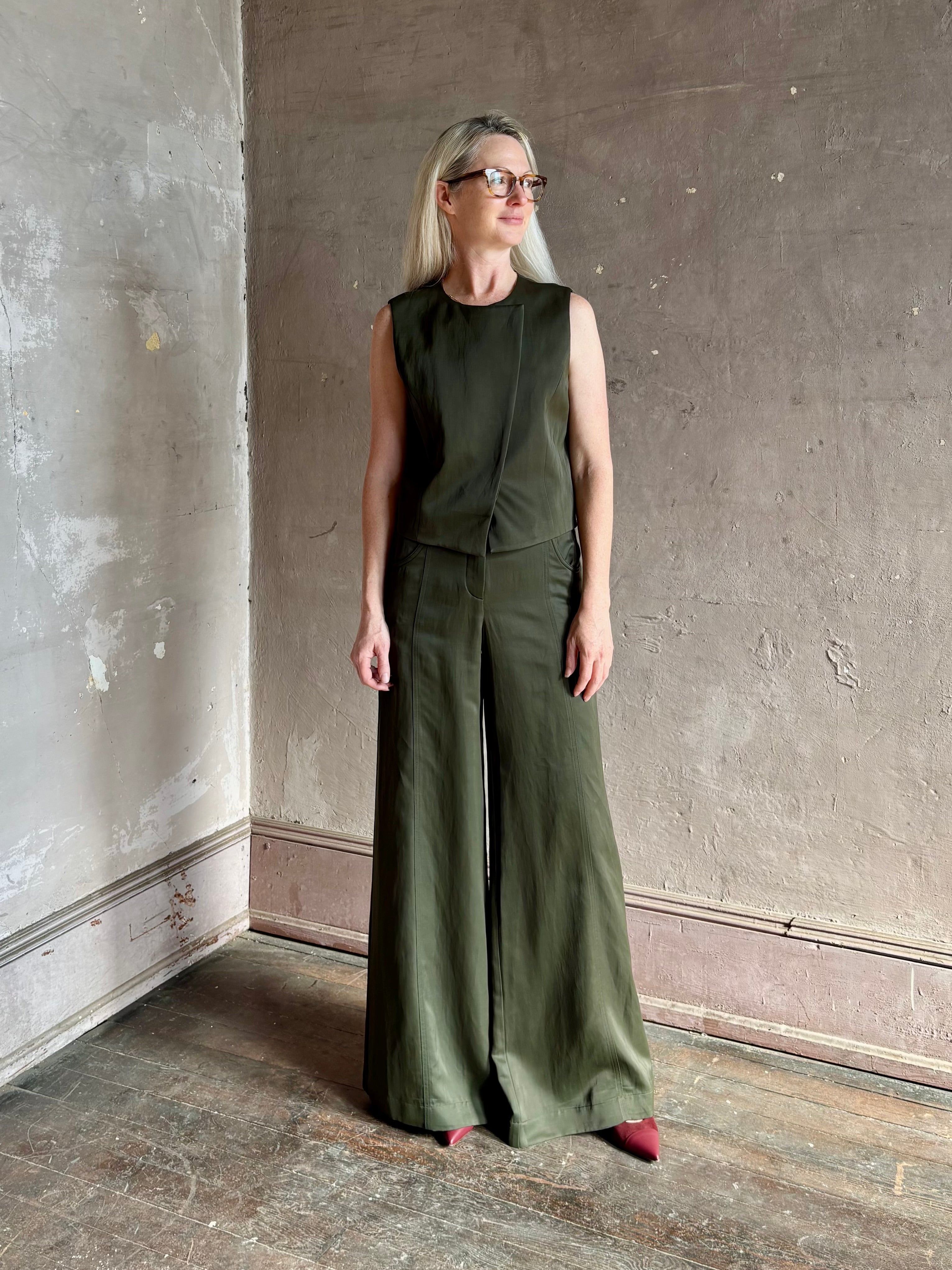 Luxury women's clothing brand TWP high neck hidden placket vest top with matching pant set in a green linen blend